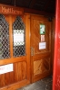Through the main doors, there is a smaller door facing you on the right
